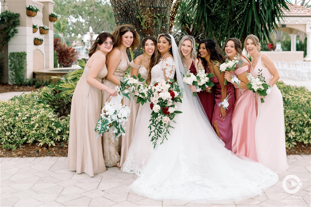 Bride and bridesmaids post wedding ceremony outdoor photos in Naples, FL.